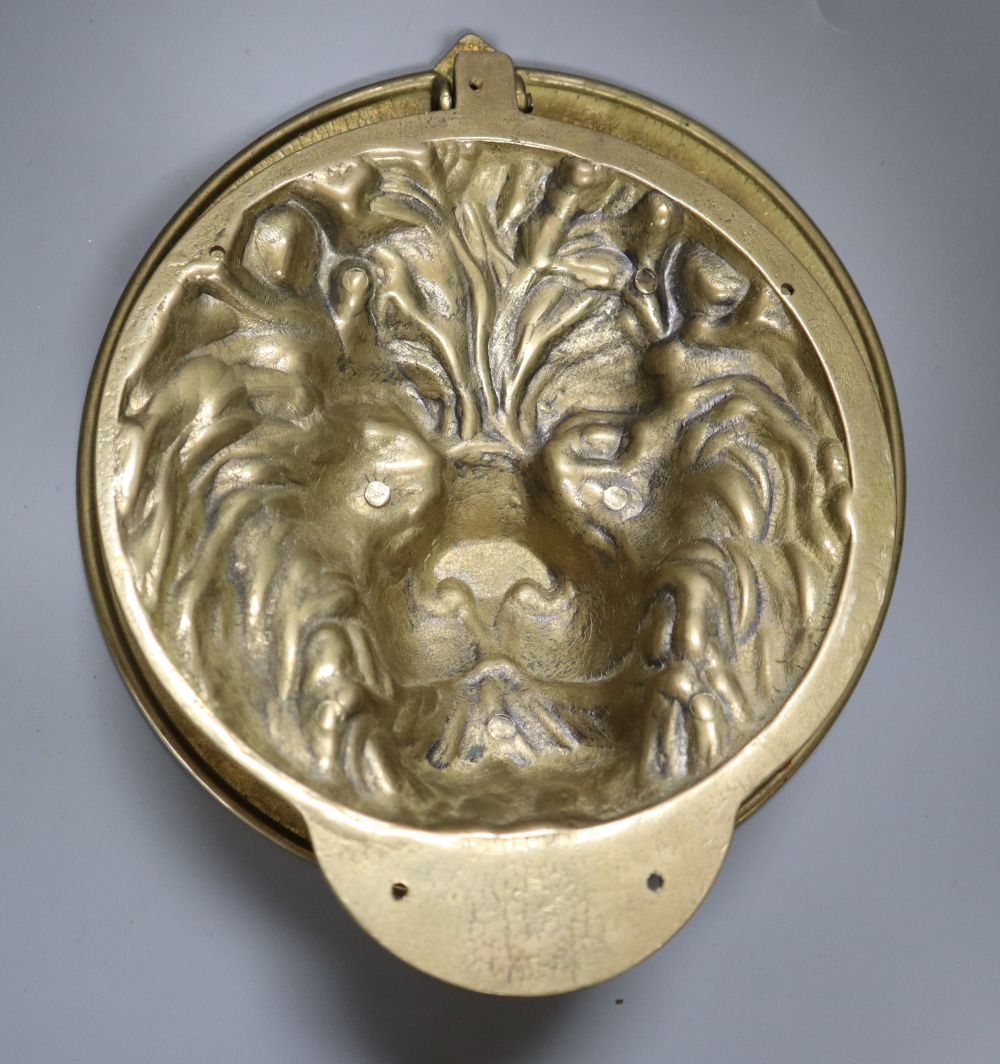 A large cast brass lions head door knocker, diameter 21cm